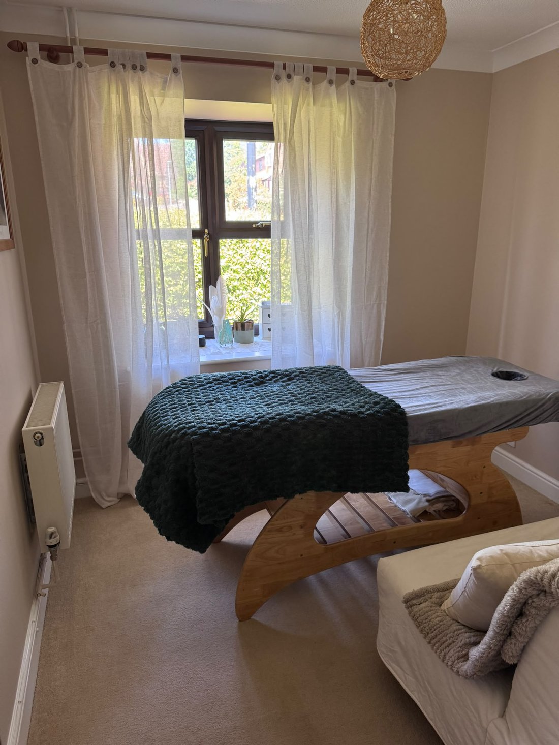Theresa's therapy room, with treatment table by a sunlit window